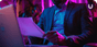 A man sitting in a chair reads a multi-page document