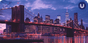 A pink, purple, and blue-scale photo of the Brooklyn Bridge at sunset with the lights of New York City reflected in the water