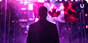 A man in a suit faces the Canadian flag