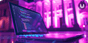 A laptop sits on a desk outside of a building with Roman columns. The keyboard is lit up and the screen has lines of code running across it.