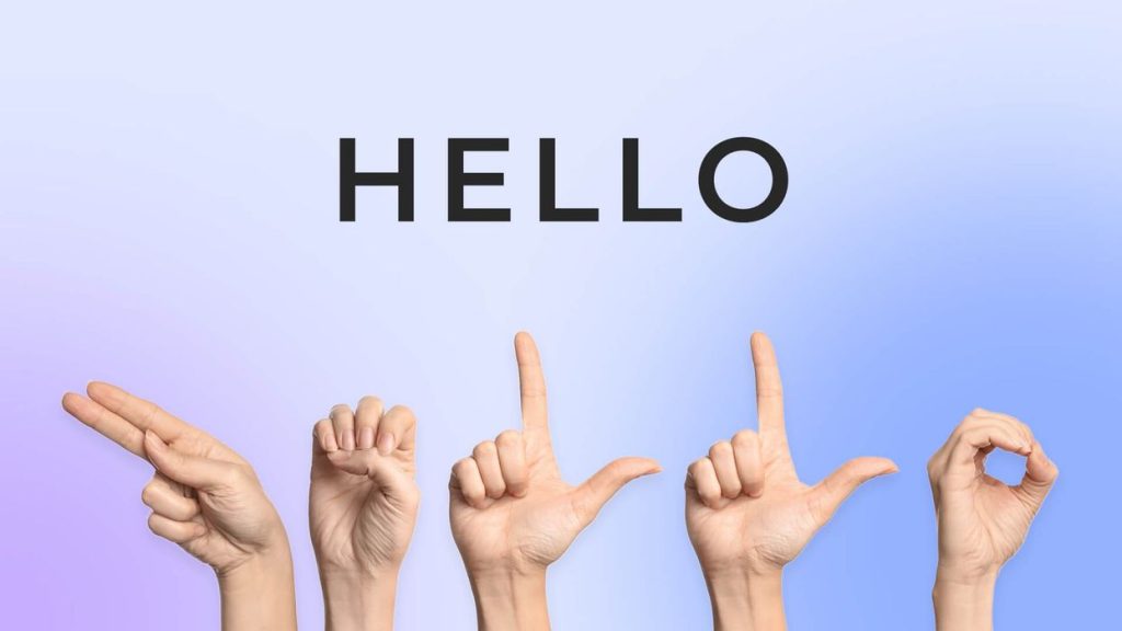 A hand spells out the word “hello” in sign language, articulating each letter of the word in sign language sequentially, h, e, l, l, o