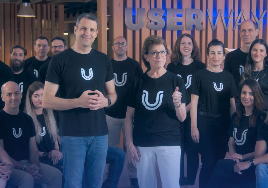 A group photograph featuring Susane Benette, Allon Mason—CEO of UserWay, and several UserWay employees in the background.