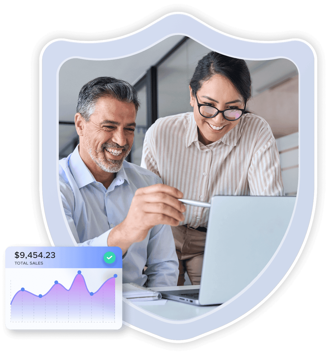 Two colleagues smiling as they look at a laptop with a sales figures chart at the bottom left